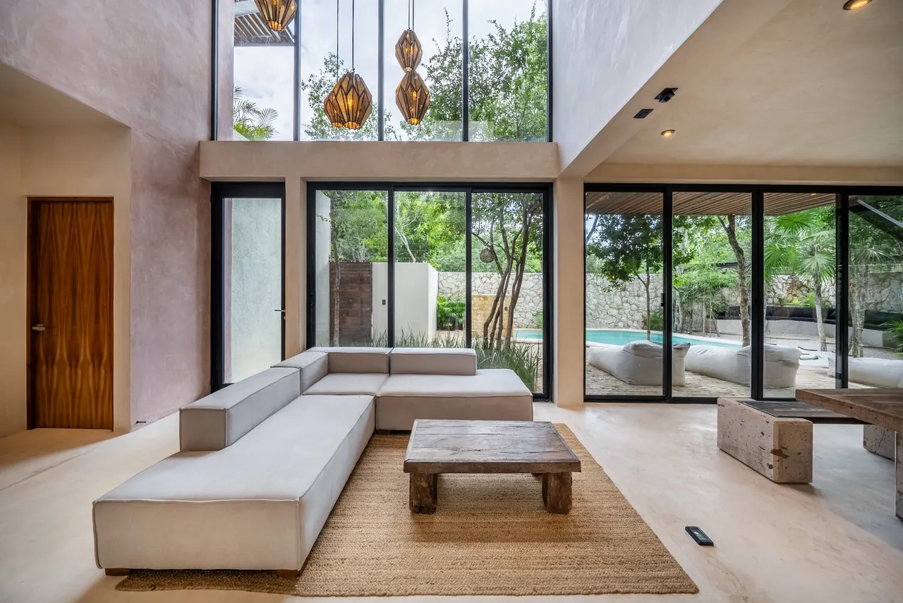 The Casa living room with pink plaster walls and double-height glass